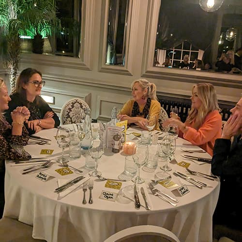 Women enjoying Really Good Conversations at a formal dinner